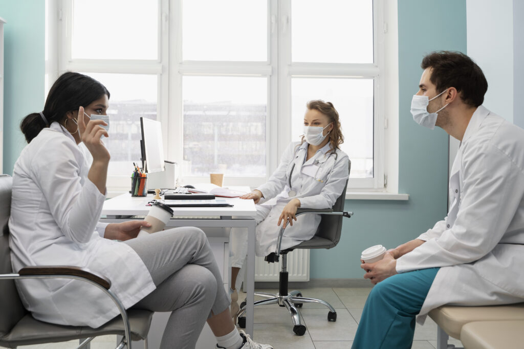 Doctors discussing work in biophilic designed room for hospital refurbishments